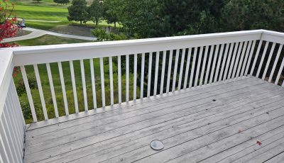 grey stained wooden deck with white railing