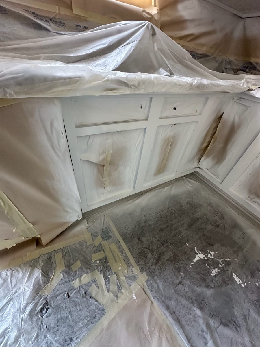 cabinets with protective coverings during painting Preview Image 1