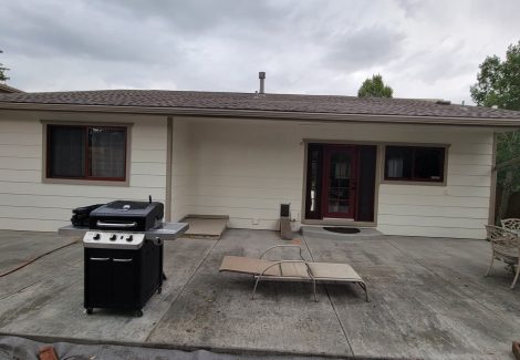 side of house with white painted siding and red trim/accents