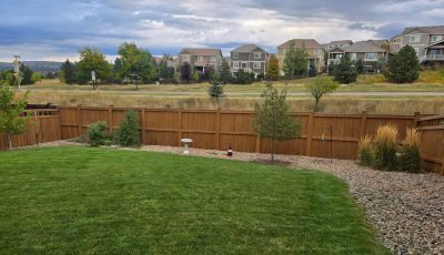 stained fence surrounding home