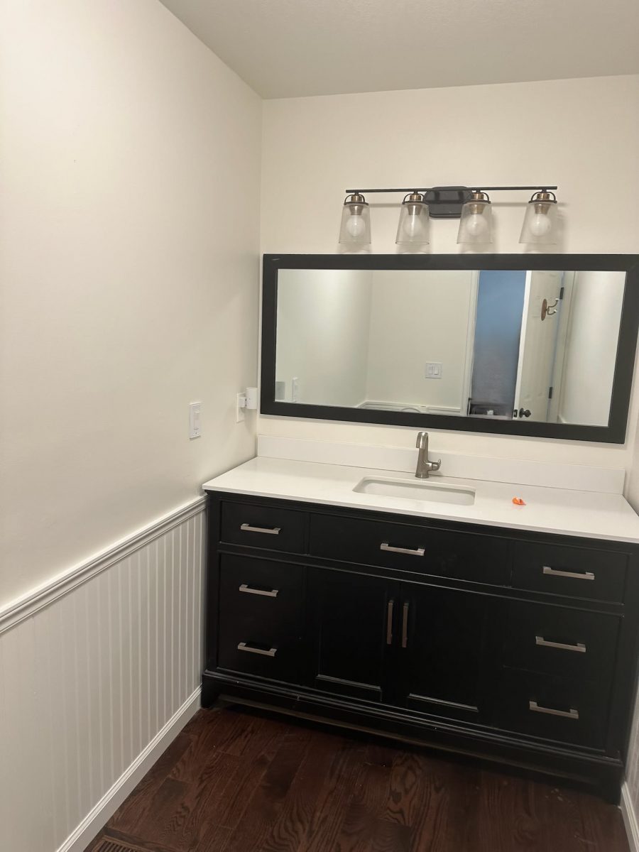 vanity and wall mounted mirror in home bathroom Preview Image 3