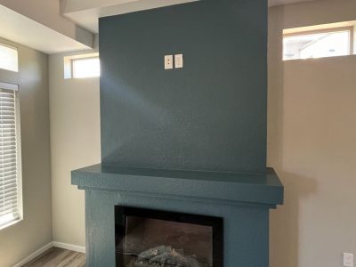 blue painted fireplace and mantle in home