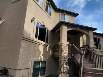 tan painted stucco house exterior with staircase