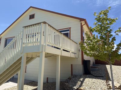 white painted deck attached to house