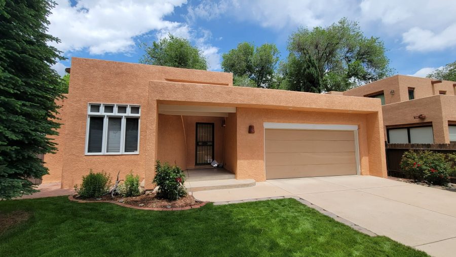front of painted stucco house with driveway and garage door Preview Image 2