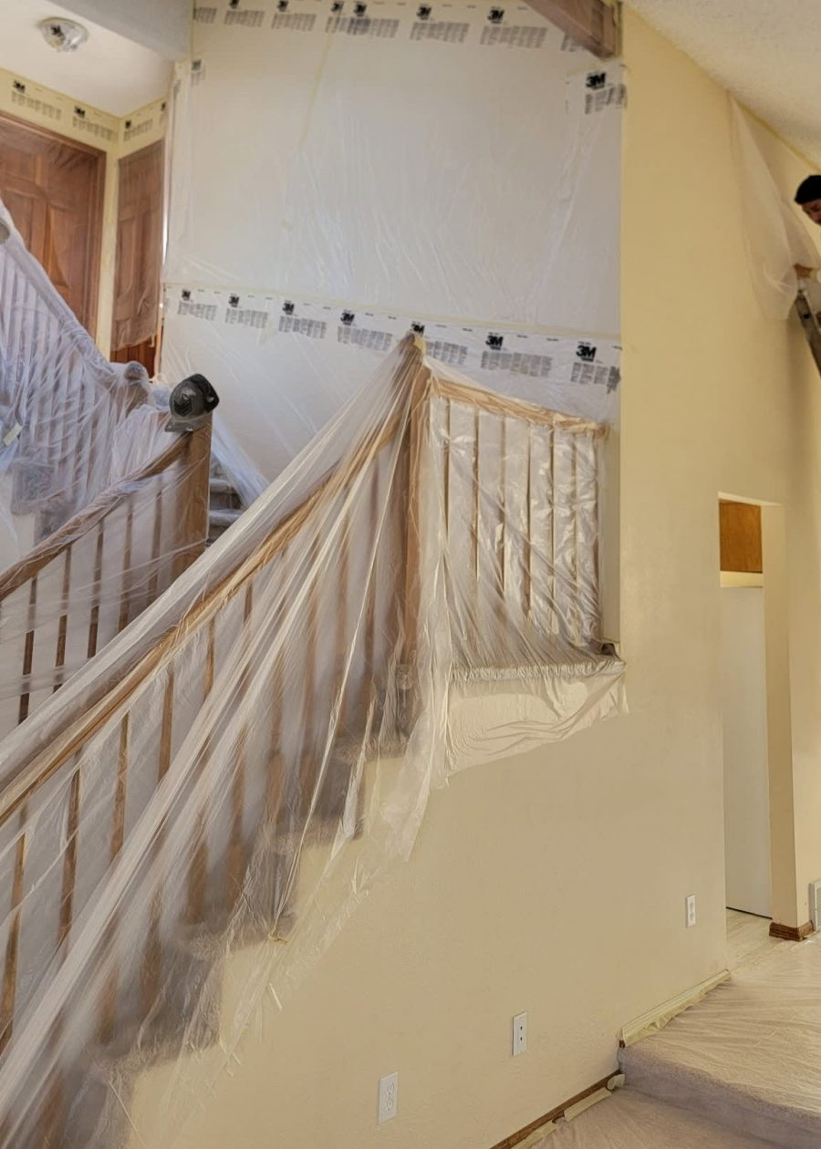 staircase covered in plastic sheeting for painting Preview Image 3