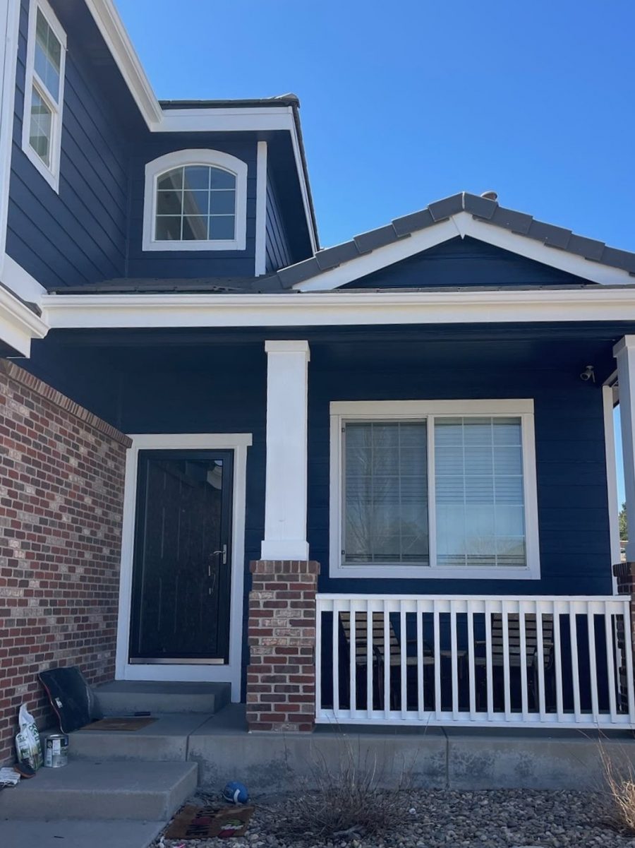 front door and porch of blue painted house