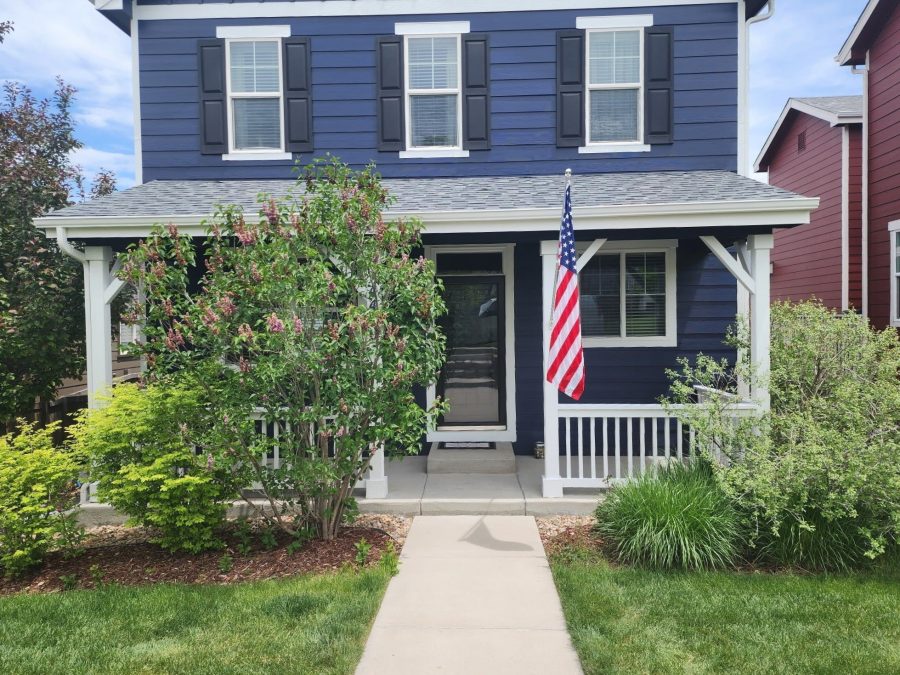 blue painted house with white railing Preview Image 2