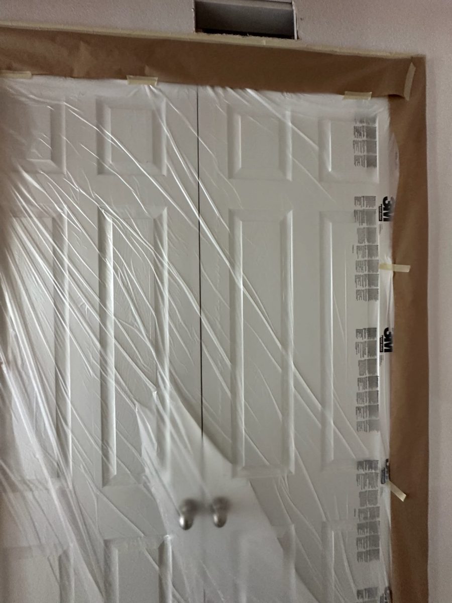 closet doors with protective plastic during painting Preview Image 6