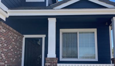 front door and porch of blue painted house