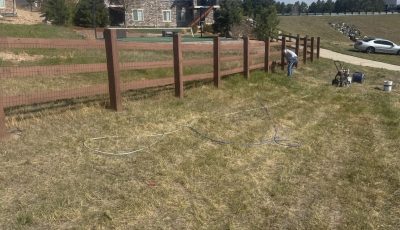 stained split rail fence surrounding CO property