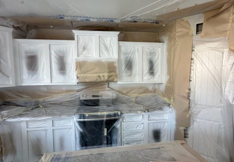 kitchen cabinets with protective coverings during painting