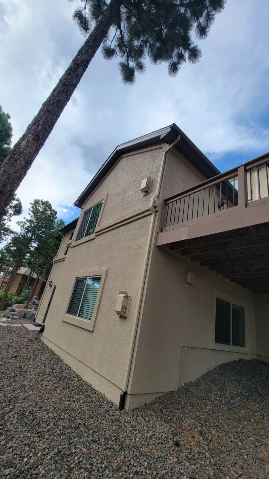 tan painted stucco house exterior with raised deck Preview Image 4