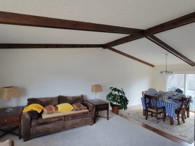 white home interior with exposed beam ceiling