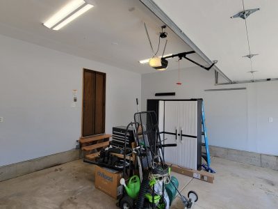 home garage with items gathered in center of room