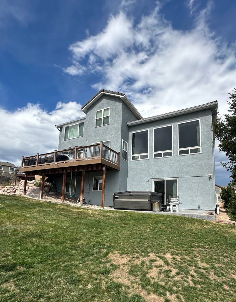 review view of house with stucco siding and wooden deck Preview Image 2