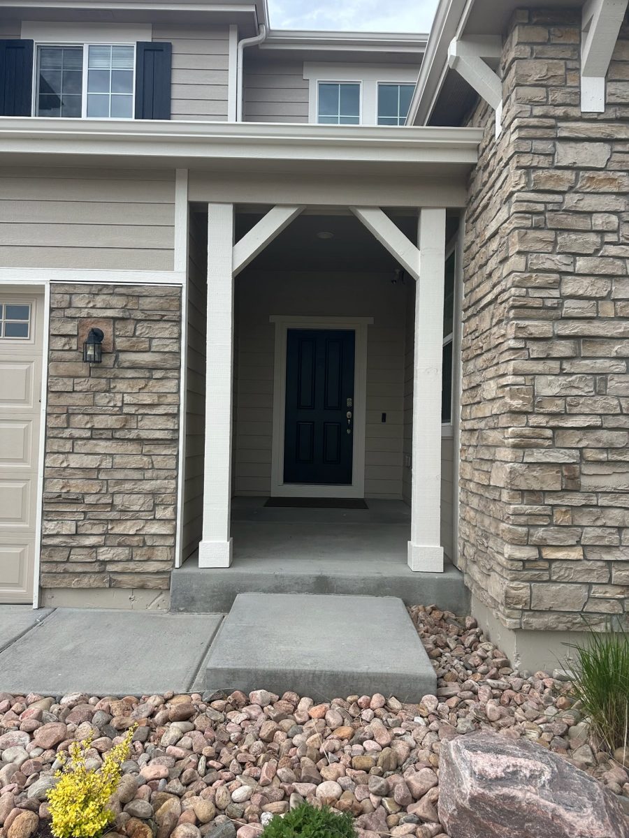 front door and covered stoop of house with stone siding Preview Image 1