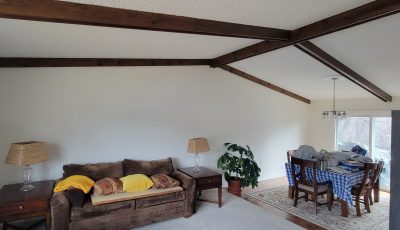 white home interior with exposed beam ceiling
