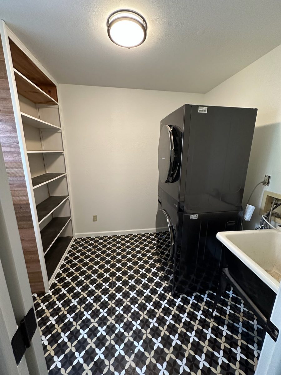laundry room in home with built in shelves and stacked washer/dryer Preview Image 1
