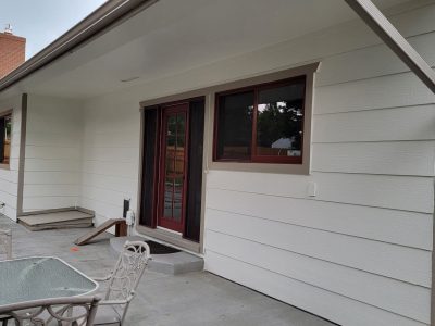side of house with white painted siding and red trim/accents