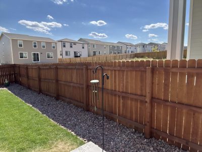stained wooden fence surrounding yard