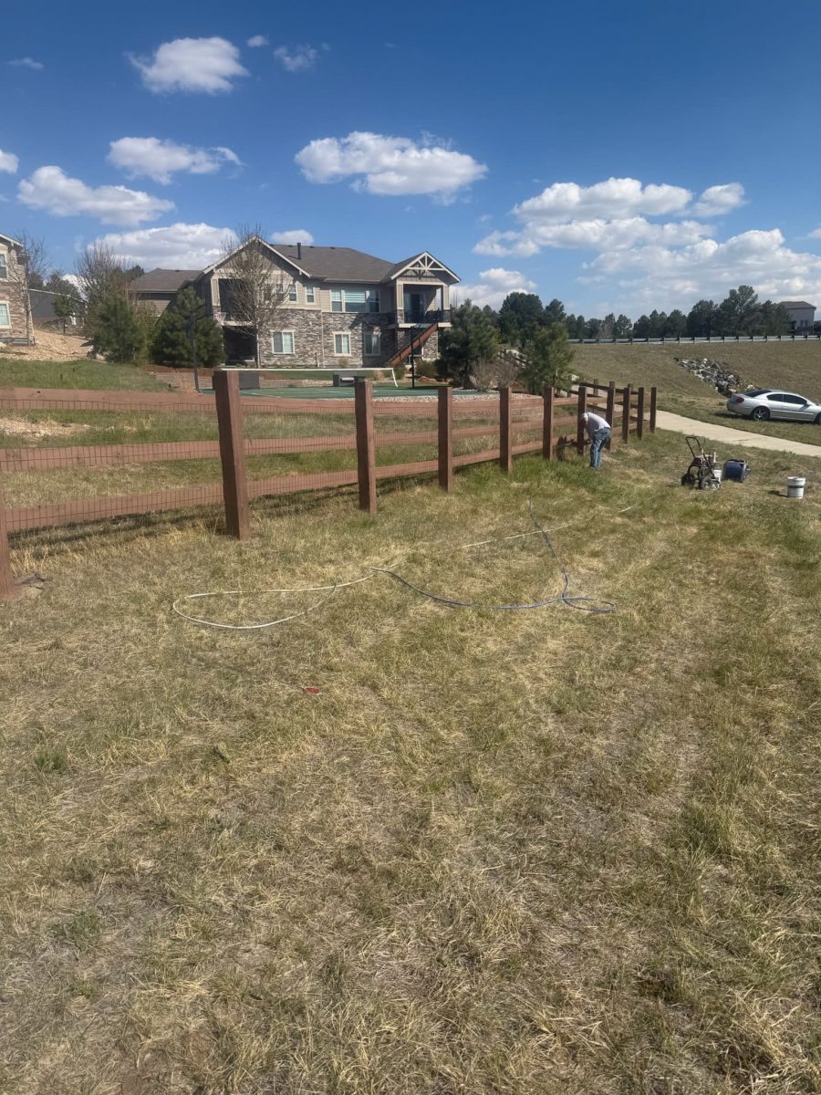 stained split rail fence surrounding CO property