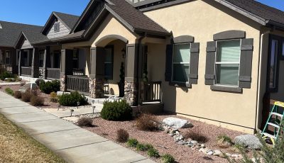 front of home with painted stucco siding