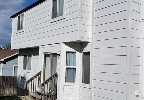 back of house with white trim and black painted soffits