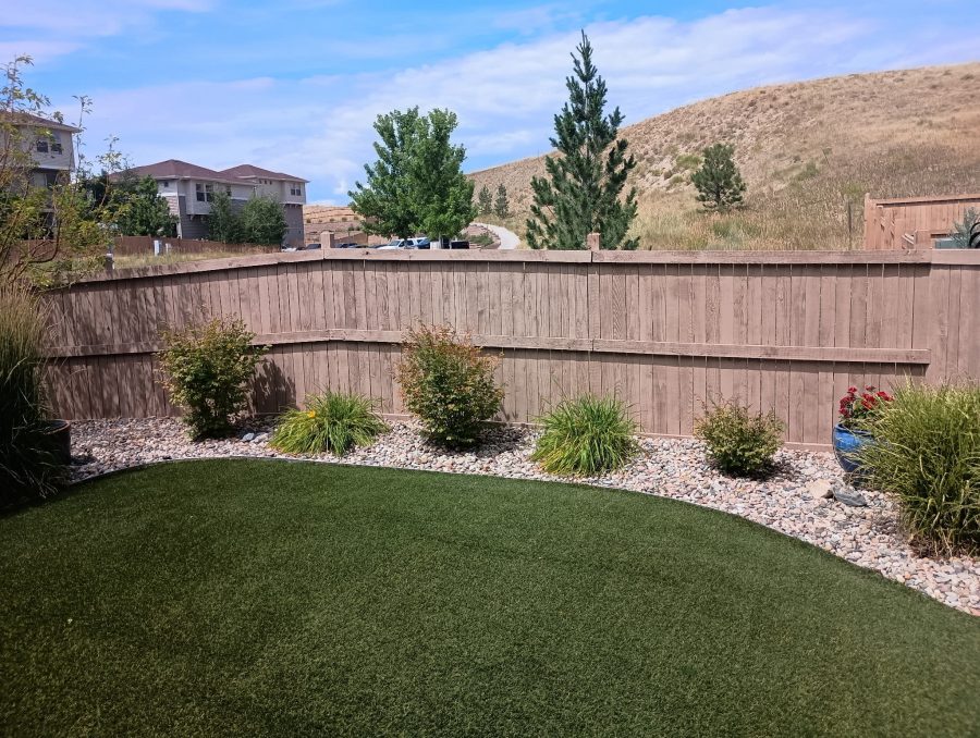 stained fence in neutral color surrounding yard