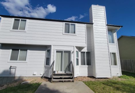 back of house with white trim and black painted soffits