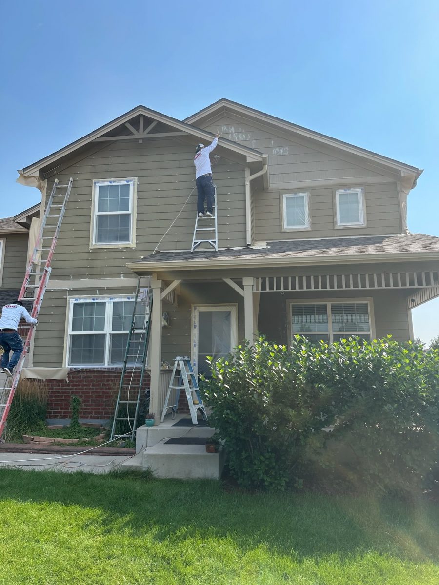 painters on ladders workin on exterior of house Preview Image 2