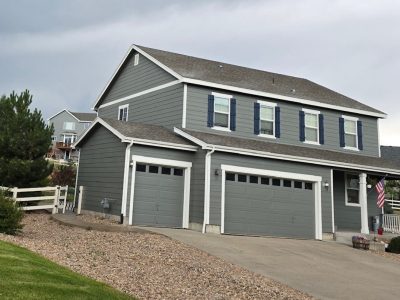 home with grey painted siding and blue shutters