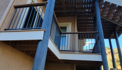 blue painted support beams outside home