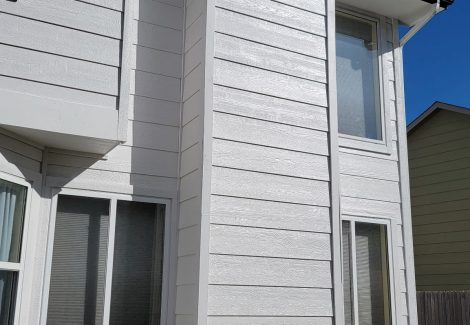 back of house with white trim and black painted soffits
