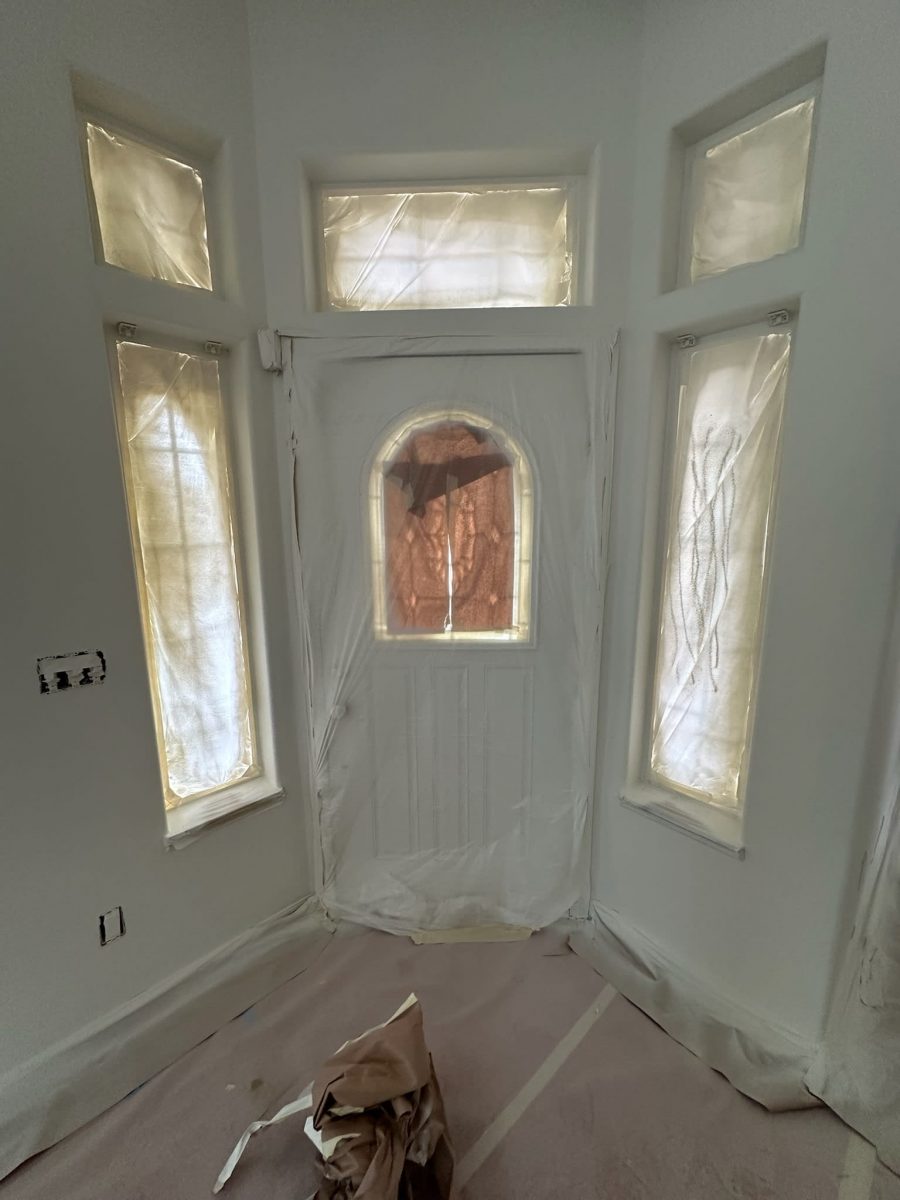 front door with protective plastic during paint project Preview Image 1