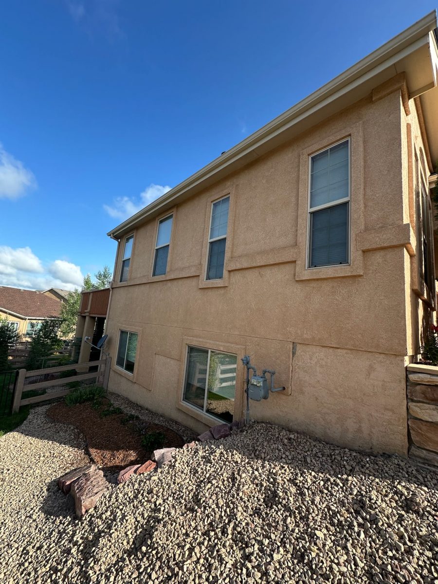side of home with repainted stucco