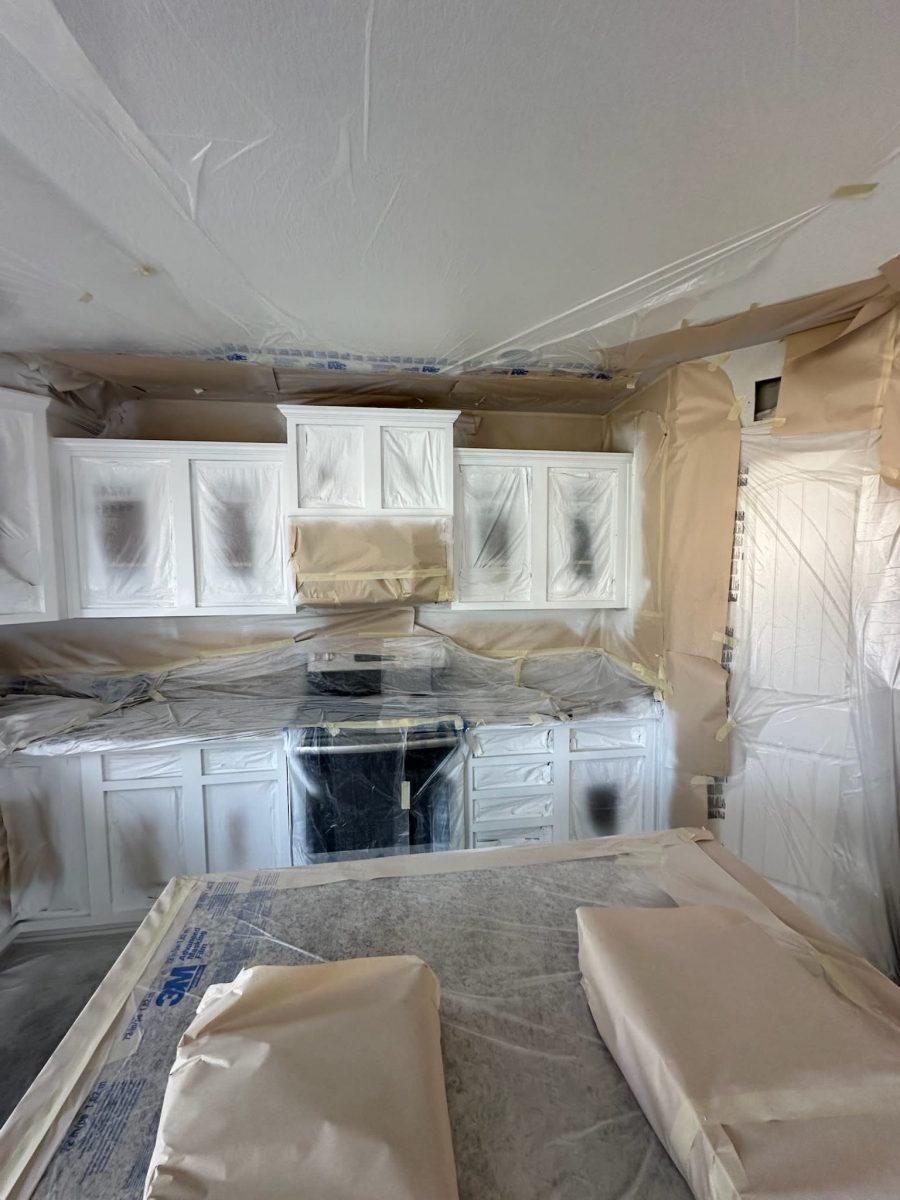 kitchen cabinets with protective coverings during painting Preview Image 2
