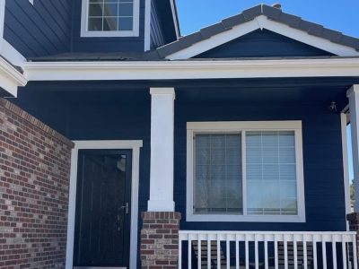 front door and porch of blue painted house