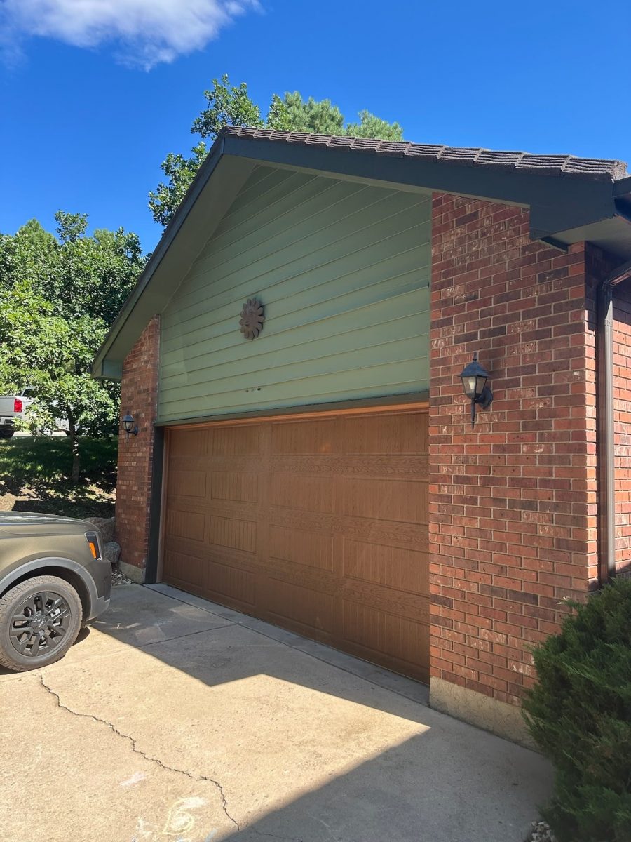 house with green painted siding and wooden garage door Preview Image 1
