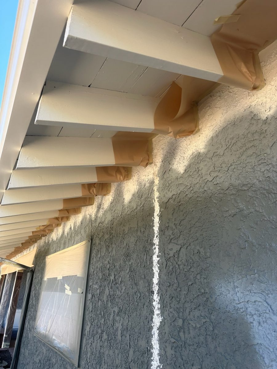 paint primer under eaves of stucco home during repaint Preview Image 3