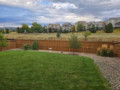 stained fence surrounding home