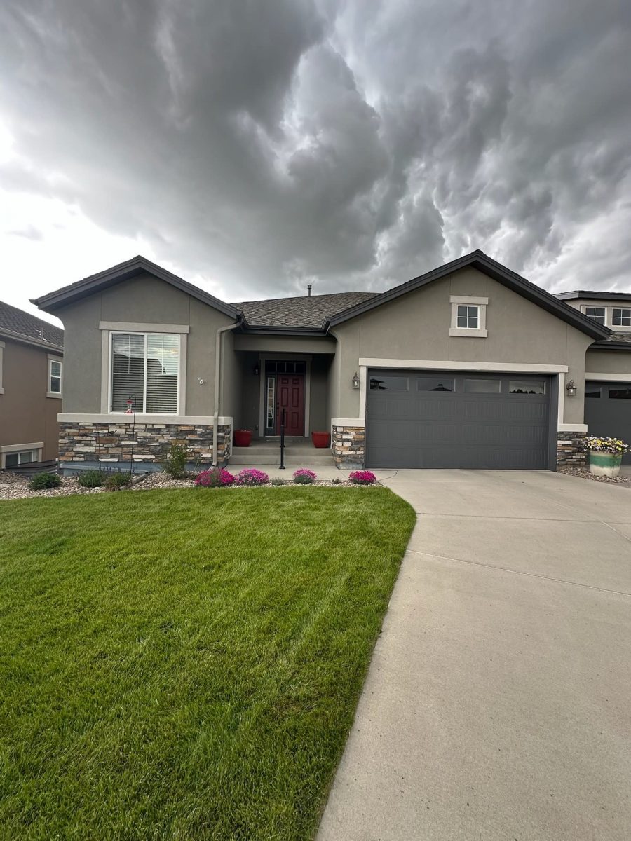 front door and garage of painted twin house with driveways
