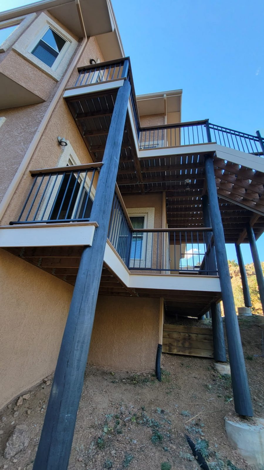 blue painted support beams outside home