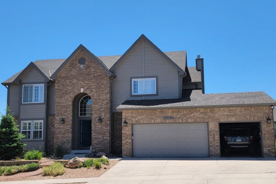 front of house with brick and siding