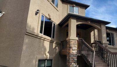 tan painted stucco house exterior with staircase