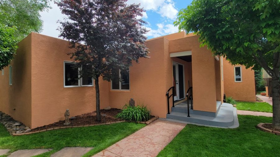 front of painted stucco house with front door