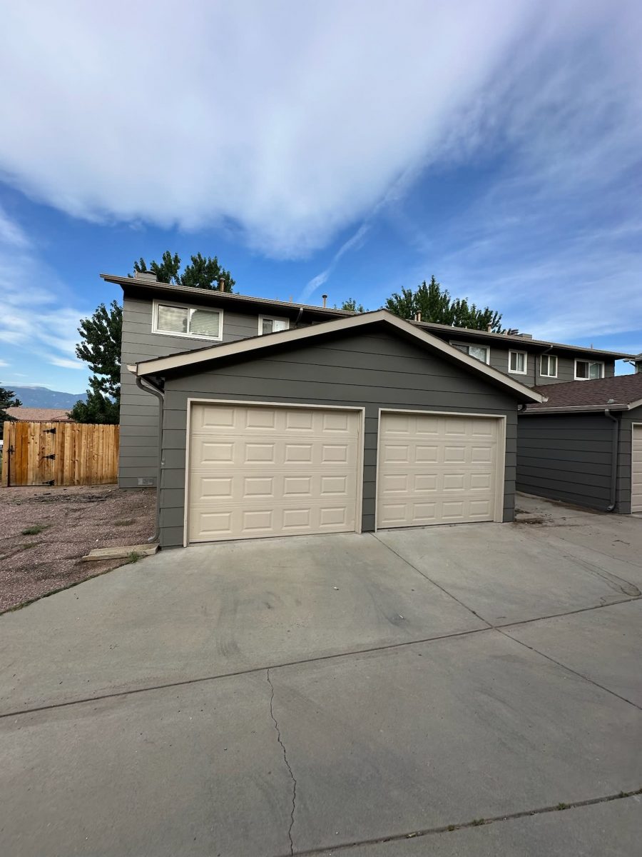 multi-family unit home garages with grey siding and beige doors Preview Image 5