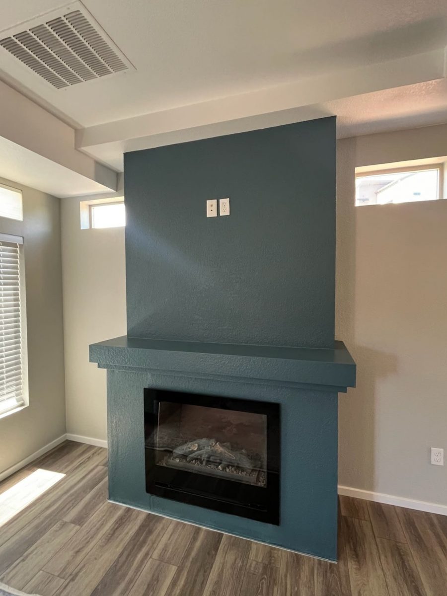 blue painted fireplace and mantle in home