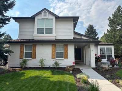 home with stained wooden shutters