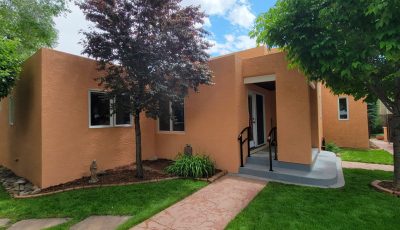 front of painted stucco house with front door